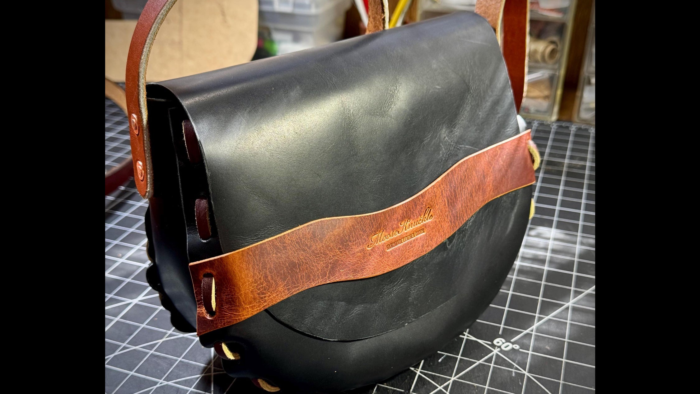 Black leather bag with brown leather strap 